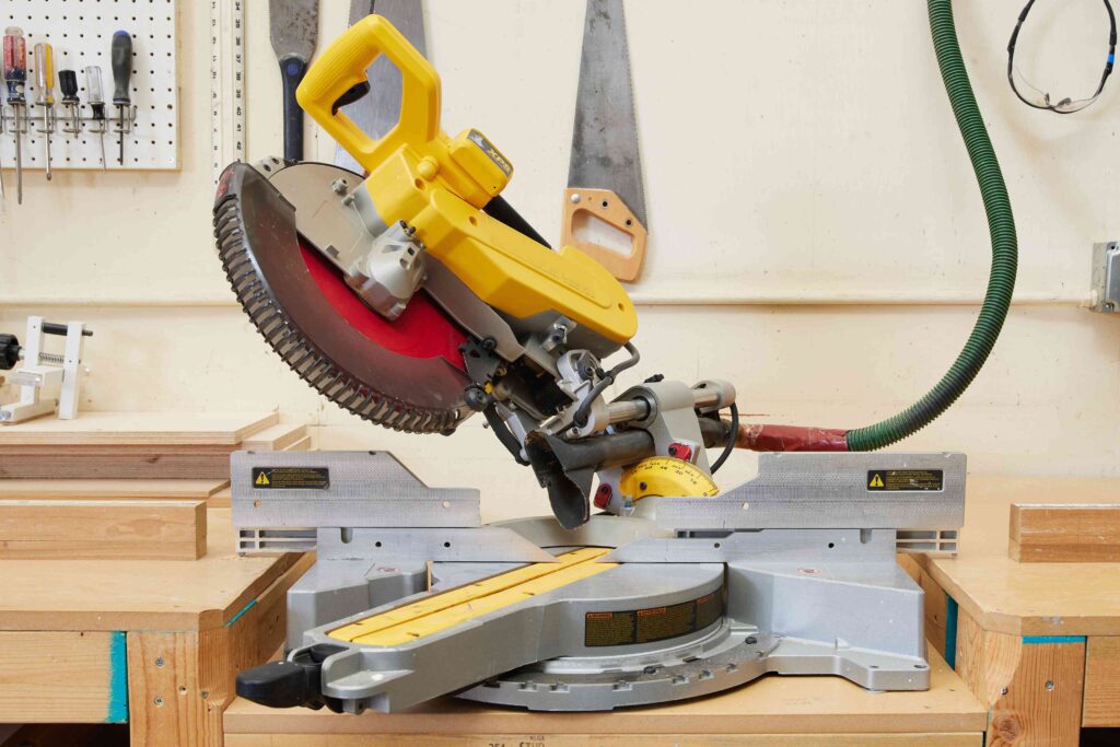 Image of a yellow chop saw at 45 degree angle. Miter Saw Safety