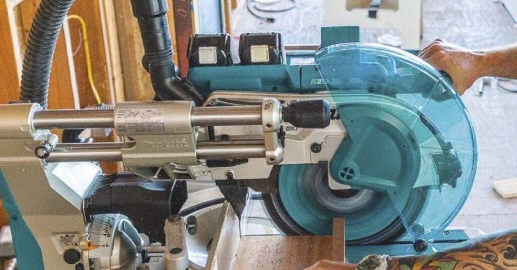 compound sliding miter saw in action cutting a board